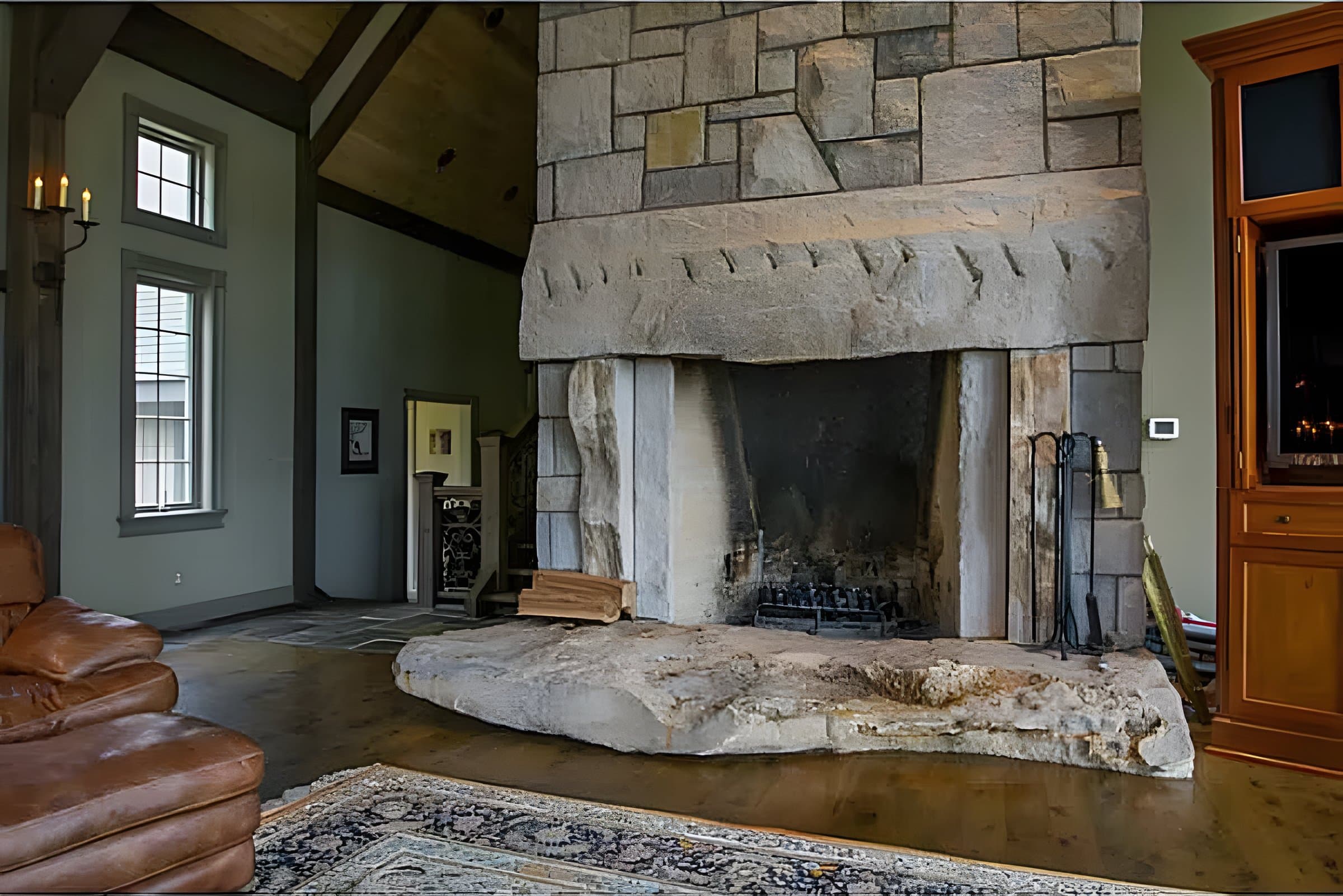 Hand-dressed stone mantel over a natural-slab hearth