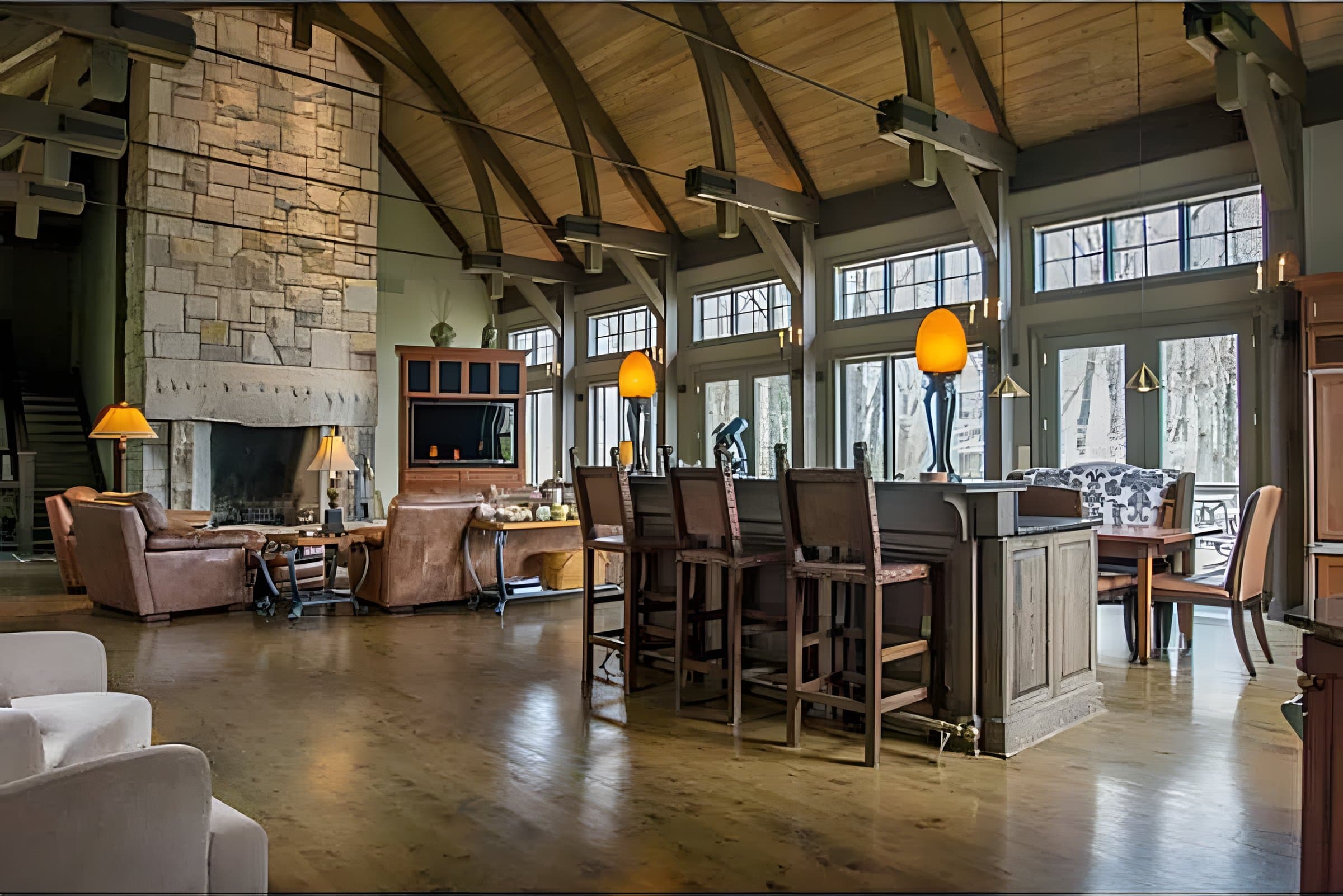 Timber-frame great room with a full-height hand-laid stone fireplace